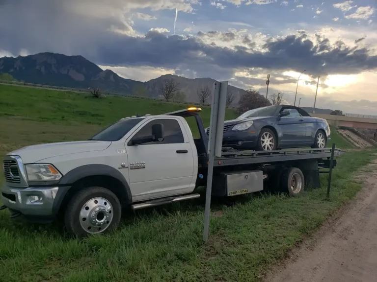 Jorge's tow truck hauling a junk sedan for cash in Commerce City, CO