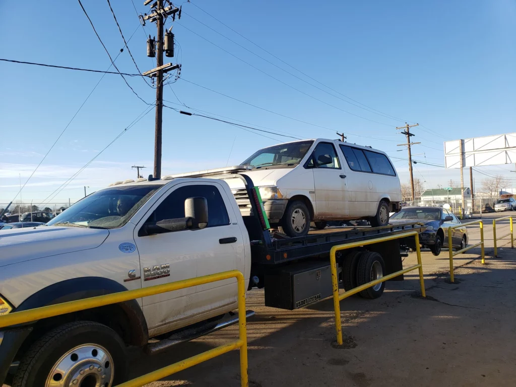 Non-running minivan picked up on Jorge's flatbed tow truck in Thornton, CO